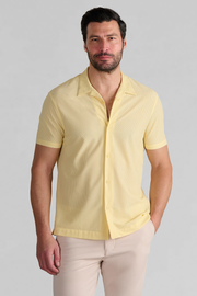 A bearded man wearing the Twillory AIR Resort Shirt Solid in yellow, a hyper-breathable shirt.