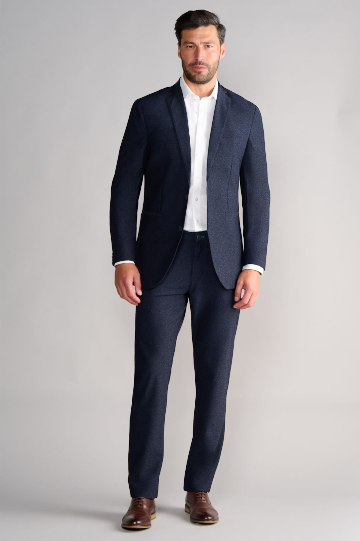 Full-length view of model wearing AIR Blazer – Heather Navy facing forward for overall fit.