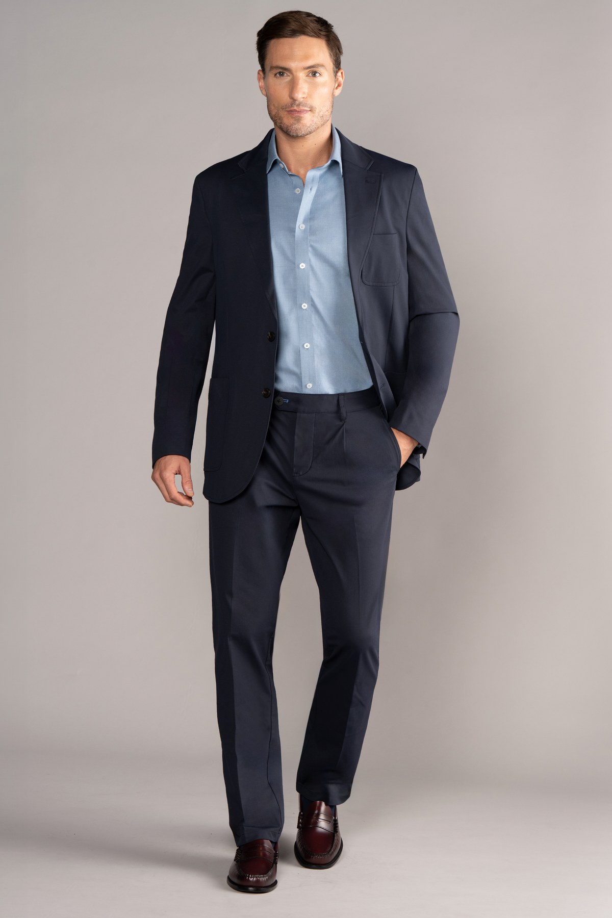 Full-length view of model wearing Performance Patch Pocket Blazer – Navy with one hand in a pocket for overall fit.