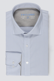 A neatly folded Twillory men’s dress shirt, Leader Houndstooth // Grey Blue, with spread collar and buttoned cuffs. Features moisture wicking, 4-way stretch fabric for comfort, and inside label reads “Twillory.”.