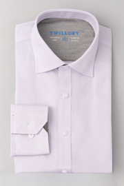 A neatly folded Twillory Leader Solid // Lavender long-sleeve performance shirt with white buttons is displayed on a plain light gray background. The inside collar shows the brand name and details about fabric and tailoring.