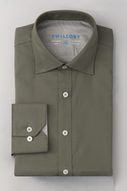 The Twillory Leader Solid // Olive is a neatly folded, long-sleeved performance shirt in olive green with white buttons, a stiff collar, blue Twillory branding inside the collar, and 4-way stretch. Displayed on a flat white surface.
