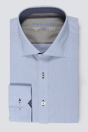 The Twillory Leader Contrast // Blue Check shirt features a blue check pattern, spread collar, 4-way stretch fabric, white buttons with dark centers, contrast trim inside the collar and cuffs, and visible Twillory branding.