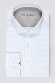 The Twillory Leader Windowpane // Sky Blue is a white dress shirt with a subtle blue grid, classic collar, buttoned cuffs, and blue branded sizing and care details inside the collar. Set against a light gray background.
