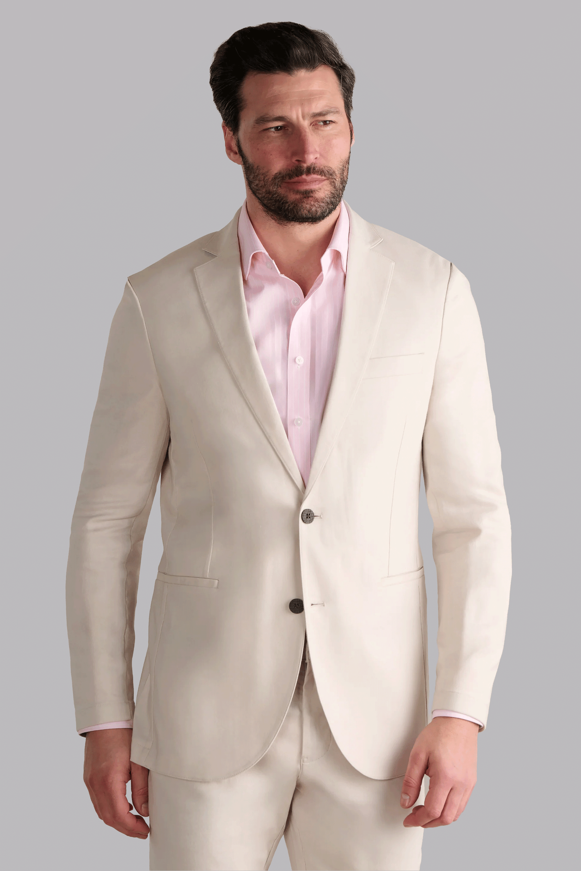 Twillory Performance Linen Blazer in Bone: An off-white, machine-washable tailored jacket crafted from a breathable blend of $45\%$ linen, $36\%$ viscose, and $19\%$ polyester. Features include 4-way stretch, proprietary 3D shoulder pads, and a non-iron finish for effortless summer style.