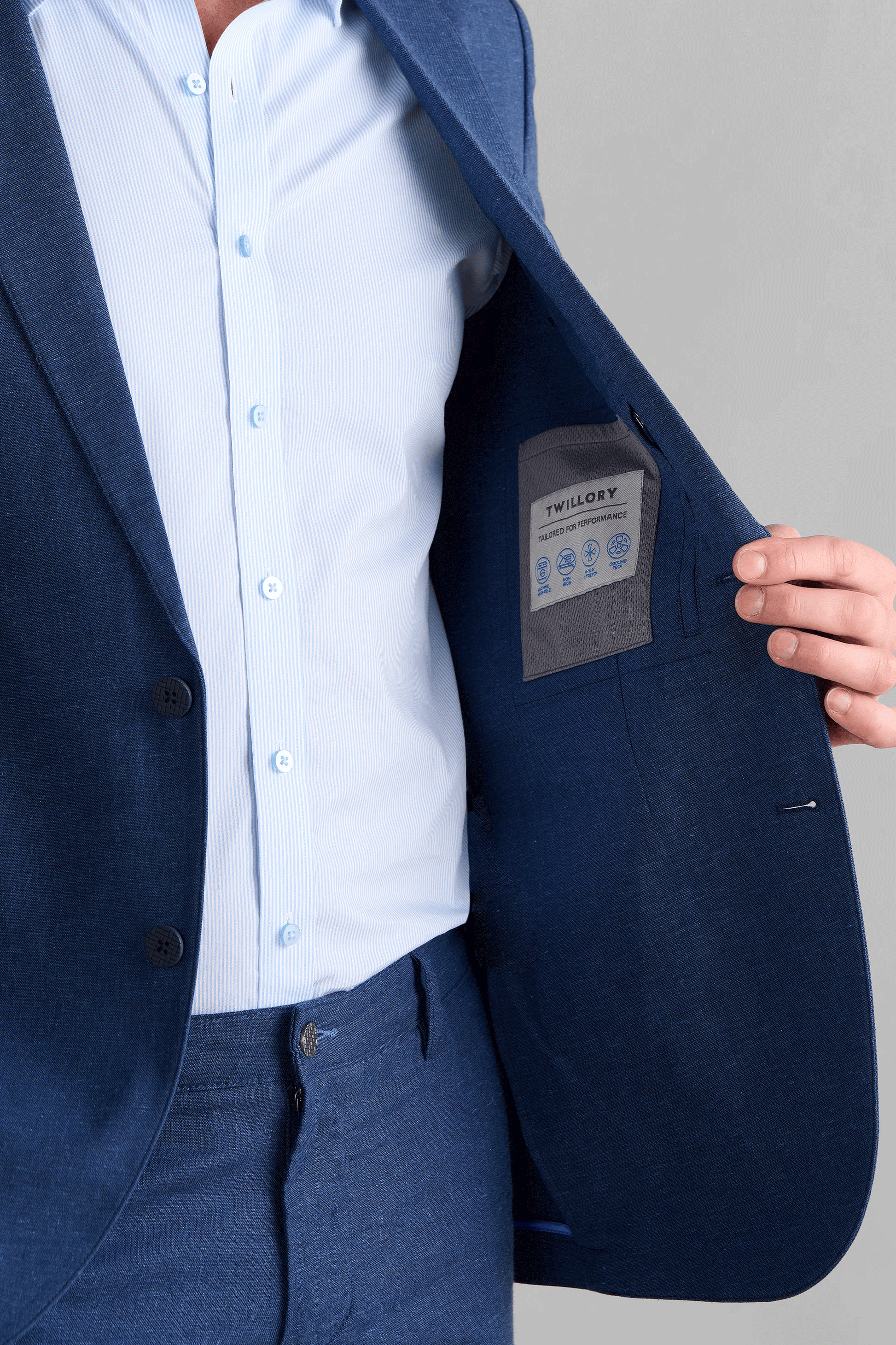 Interior view of the Twillory Performance Linen Jacket showcasing the unlined, breathable construction. Visible technical features include a zippered internal security pocket and a specialized sunglasses pocket within the moisture-wicking linen-blend fabric.