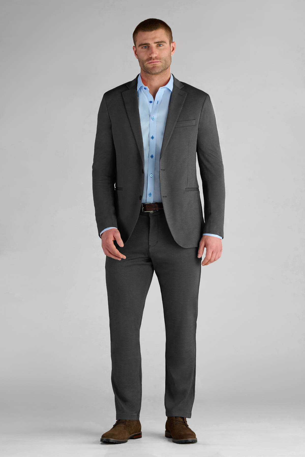 Full-length view of model wearing Performance Blazer – Charcoal facing forward for overall fit.