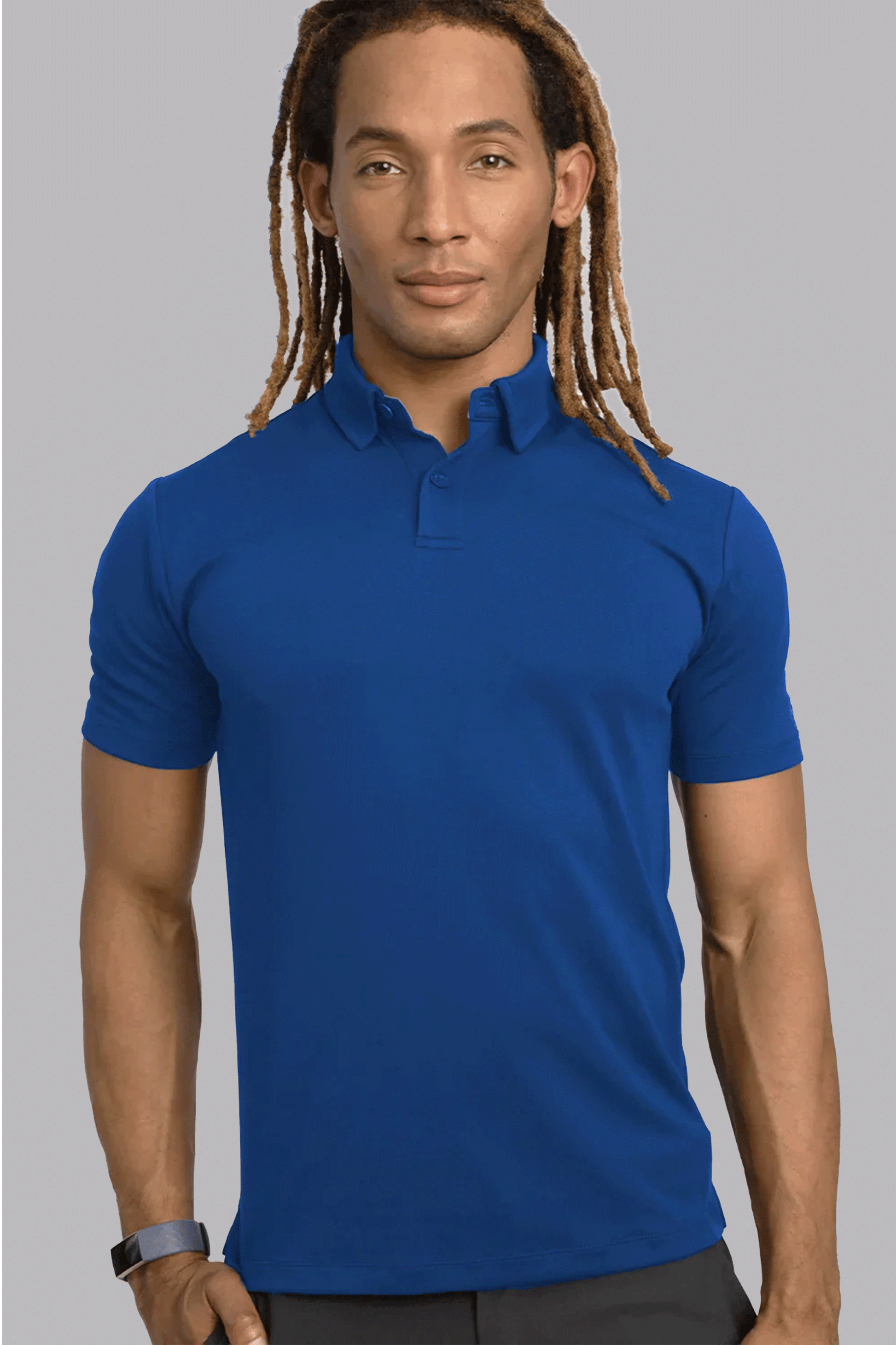 A man with light brown skin and long, blond-tipped dreadlocks wears the Twillory Short Sleeve Polo Solid in Twilight. He stands facing forward with a black wristband and a neutral expression against a light gray background.