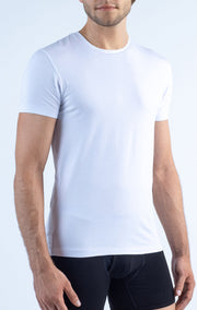 A man models the Twillory Performance Undershirt 3 Pack // Crew Neck, featuring sweat-wicking fabric. He stands against a light background with arms relaxed, highlighting the shirt’s slim fit and comfort.