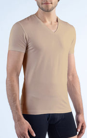 A man models Twillory’s Performance Undershirt 3 Pack // V Neck - Tonal in beige and black boxer briefs, with a partially visible face against a light blue background that emphasizes the fitted, short-sleeve look.