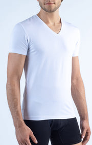 A man models the Twillory Performance Undershirt 3 Pack // V Neck in plain white with black boxer briefs, standing against a light background. The photo showcases the snug fit and smooth texture of the undershirt.