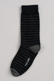 A Twillory Black Stripe sock featuring thin white stripes, gray heel and toe, and "TWILLORY" on the sole is laid flat on a light gray background—sure to become one of your favorite socks.