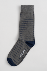 The Twillory Grey Stripe sock features thin dark stripes, a solid navy toe, heel, and cuff, and "TWILLORY" in white on the sole. Displayed flat on a light background—perfect for finding your next favorite pair.