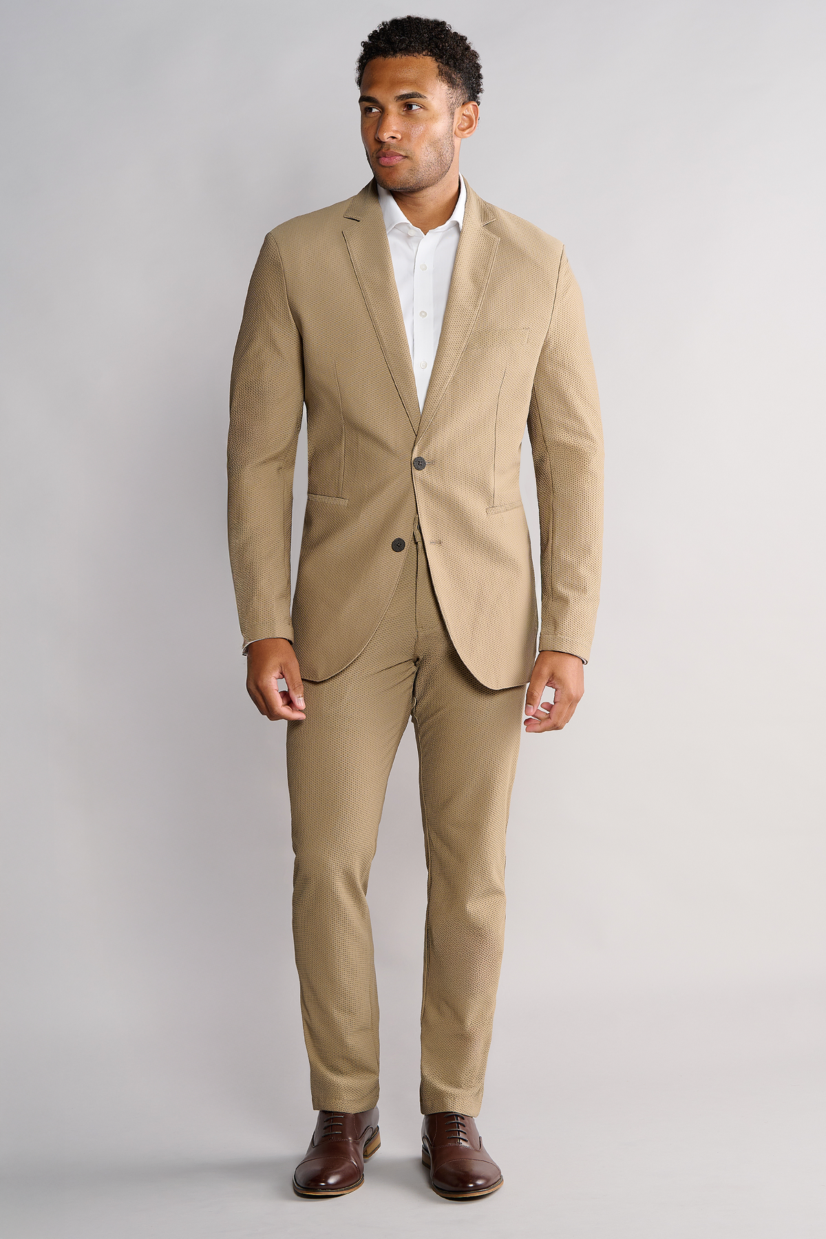 Full-length view of model wearing AIR Blazer – Khaki looking left for overall fit.