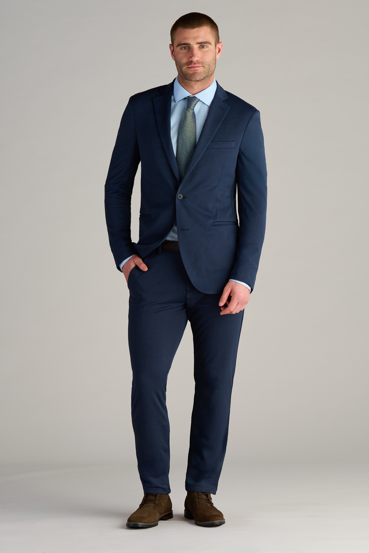 Model wearing Circular Knit Blazer – Heather Navy with one hand in a pocket, front fit visible.