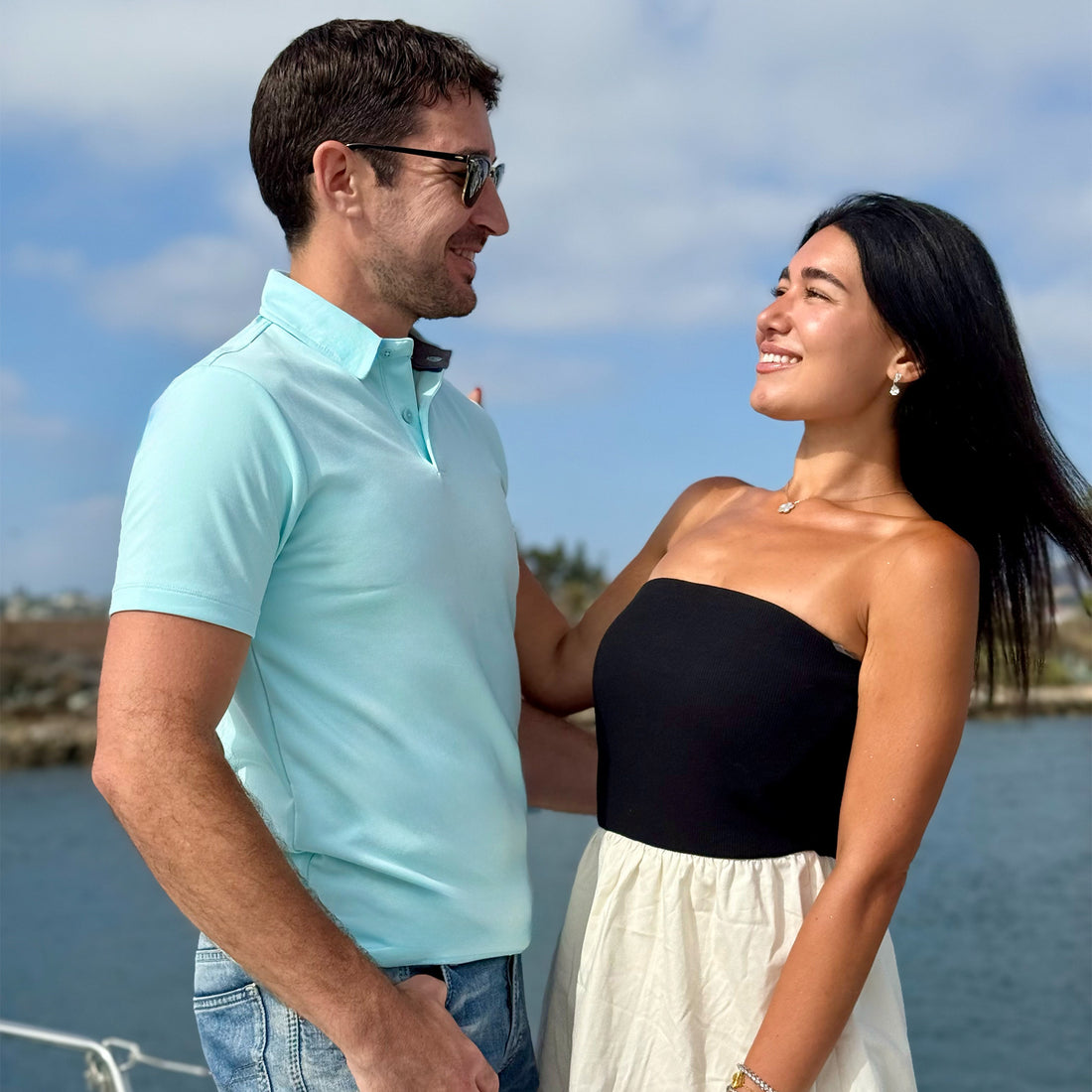 Man facing woman while wearing a powder blue performance polo 