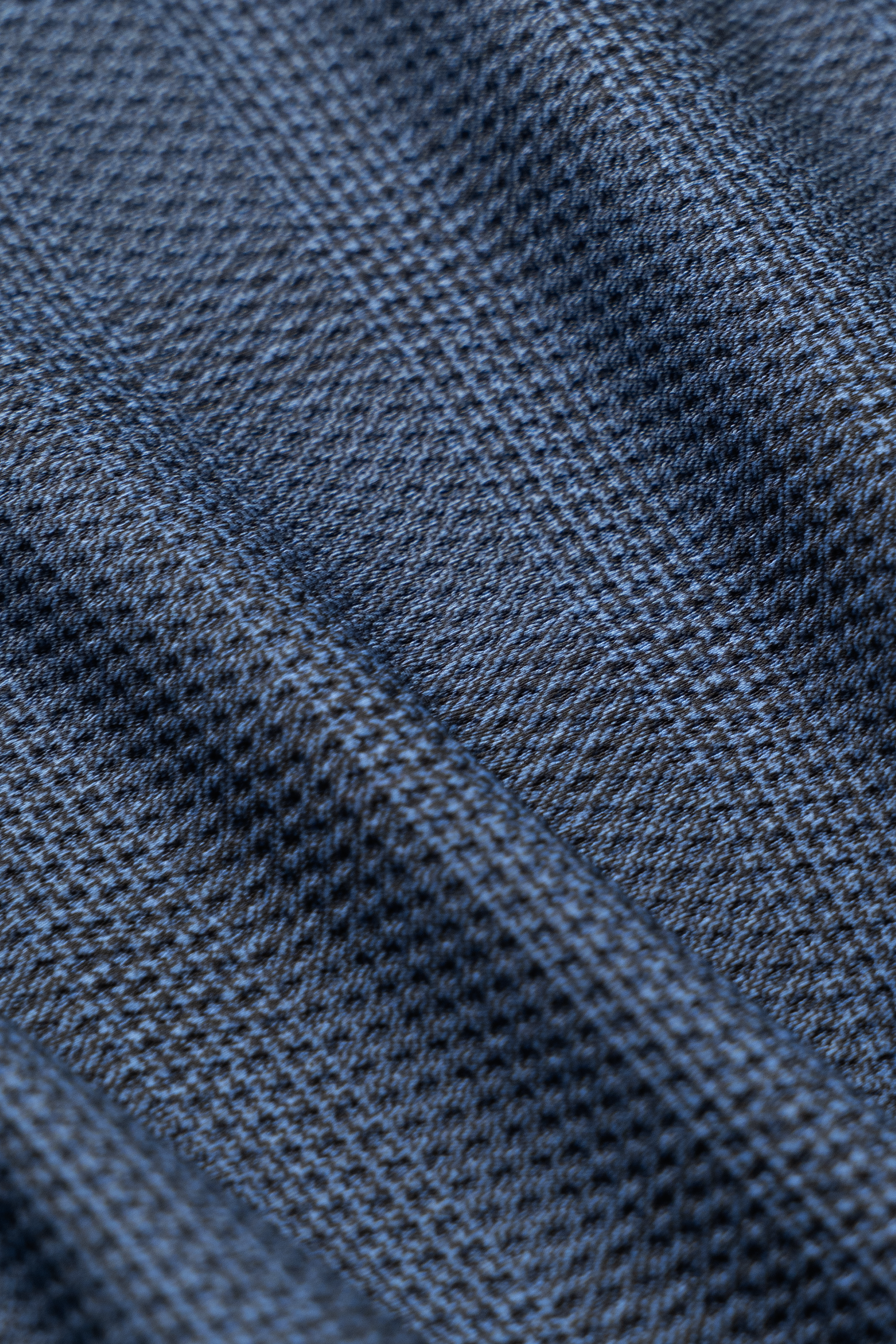 Close-up of the AIR Blazer // Blue Prince of Wales, showing blue and gray plaid fabric with diagonal lines, a textured woven look, and cooling mesh for 360° airflow.