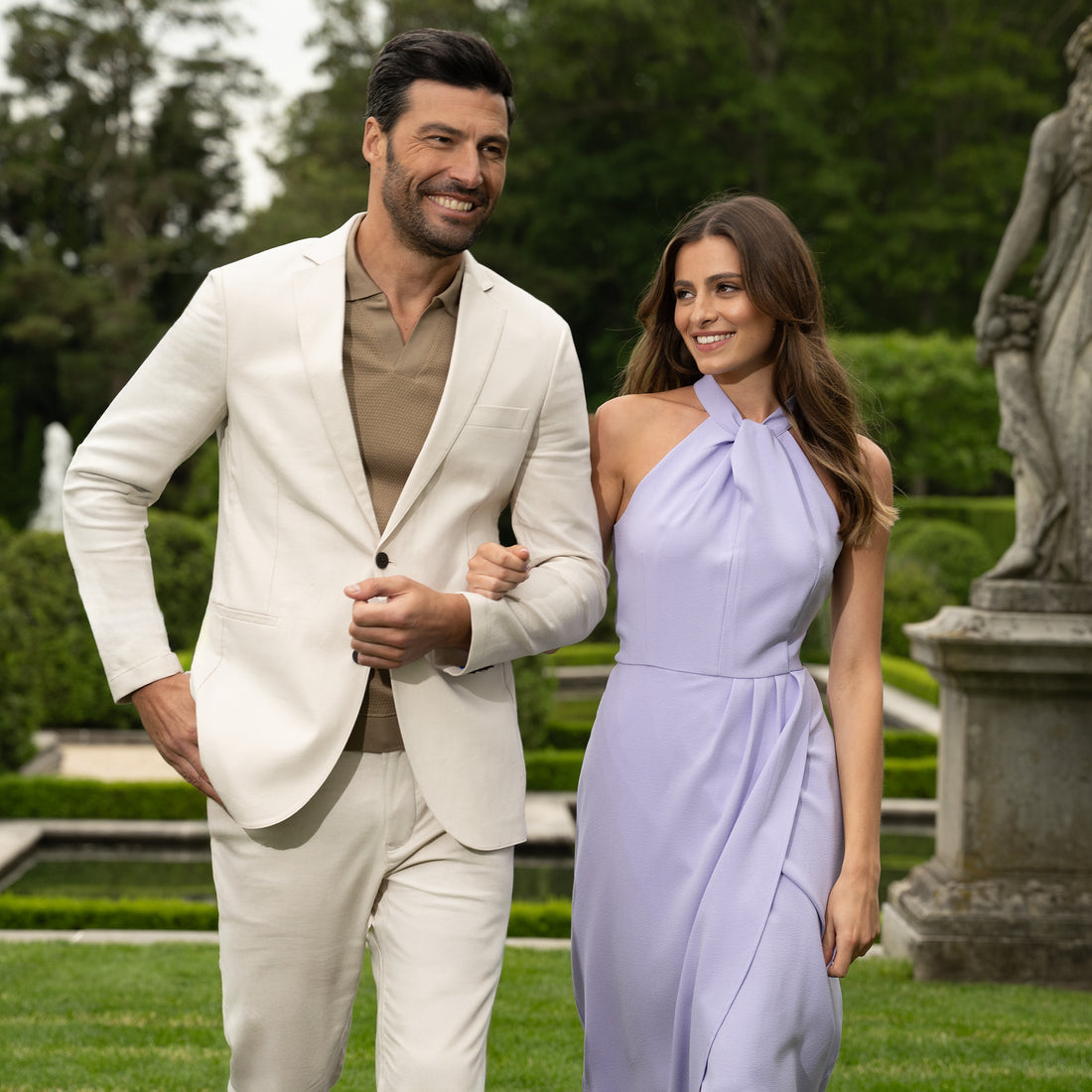 model walking with date wearing sepia sweater polo in garden