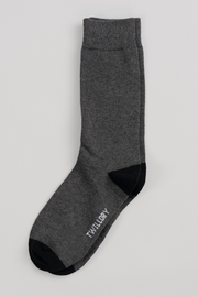 A pair of Twillory Grey Solid crew socks with black toes and heels is stacked neatly on a light gray background. "TWILLORY" is printed in white near the toe, making these your new favorite socks.