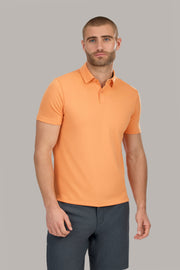 A man in a Twillory Short Sleeve Polo Solid in Tangerine.