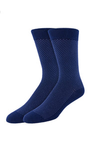 The Twillory Navy Pin Dot socks feature a subtle pattern of small white dots on navy blue. These crew-length socks are shown against a plain white background.