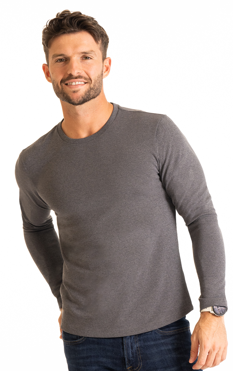 Man wearing a grey long-sleeve shirt and blue jeans.